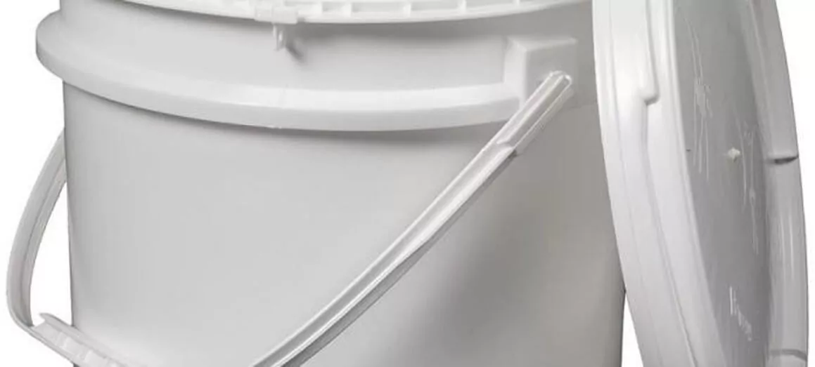 A large white plastic bucket with a lid slightly ajar. It has a sturdy handle and a smooth surface. The bucket is set against a plain white background.